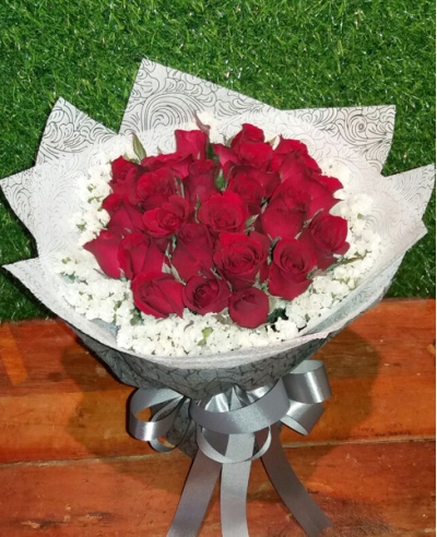 24 red roses with greenery